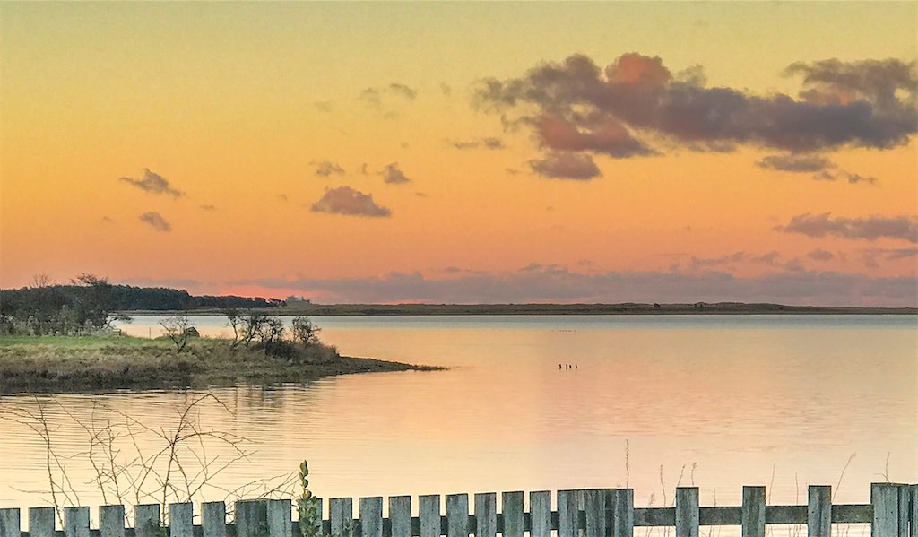 Budle Bay sunset enjoyed from the Waren Mill decked area